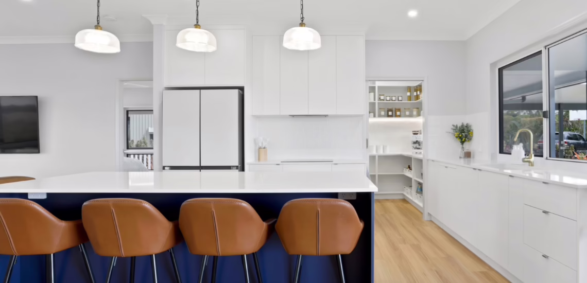 Modern grey kitchen with herringbone splashback and black accents by NV Builders Mackay