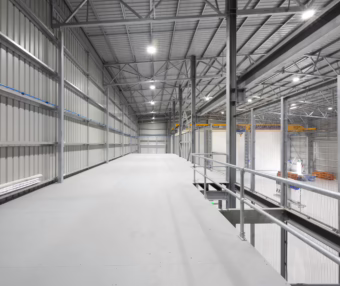 Industrial mezzanine construction with steel framework and safety railings by NV Builders in Mackay