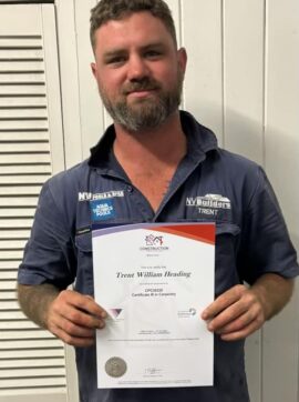 Trent celebrating Certificate III in Carpentry after 7 years with NV Builders Mackay
