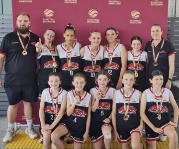 U12’s Meteorettes basketball team celebrating tournament success with NV Builders support